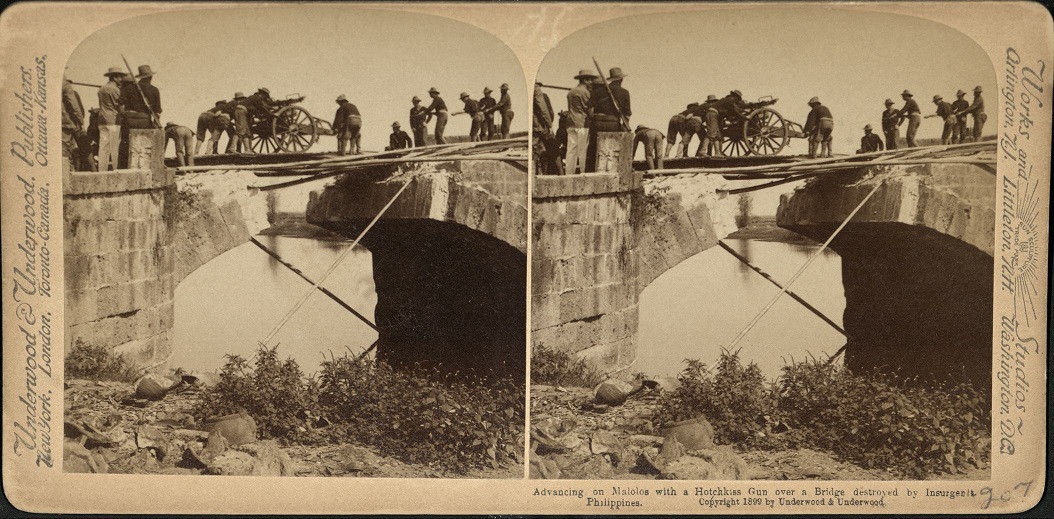 Advancing on Malolos with a Hotchkiss Gun over a Bridge destroyed by Insurgents, Philippines.